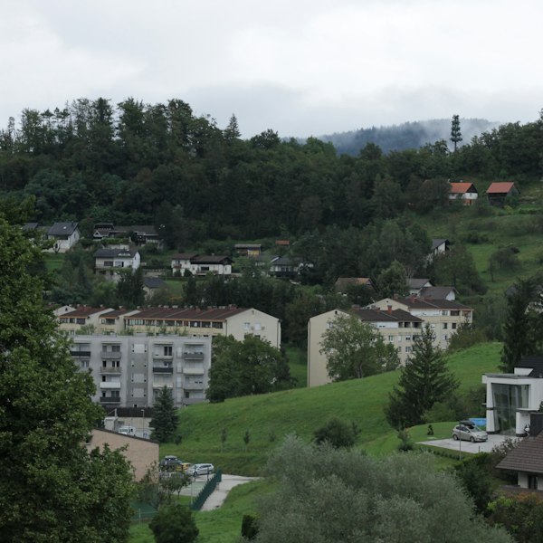 Houses and buildings are nestled in a green valley