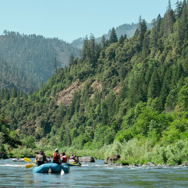 a group of people on a raft in a river