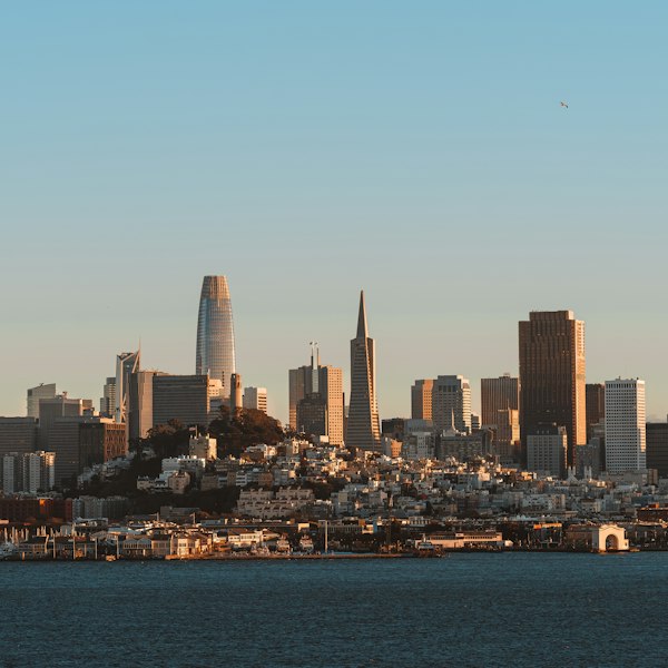 a city skyline with a body of water in the foreground