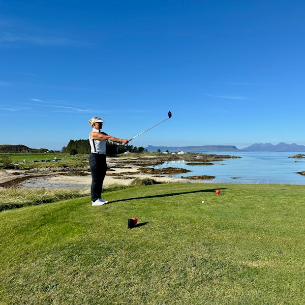 A man is playing golf on a golf course