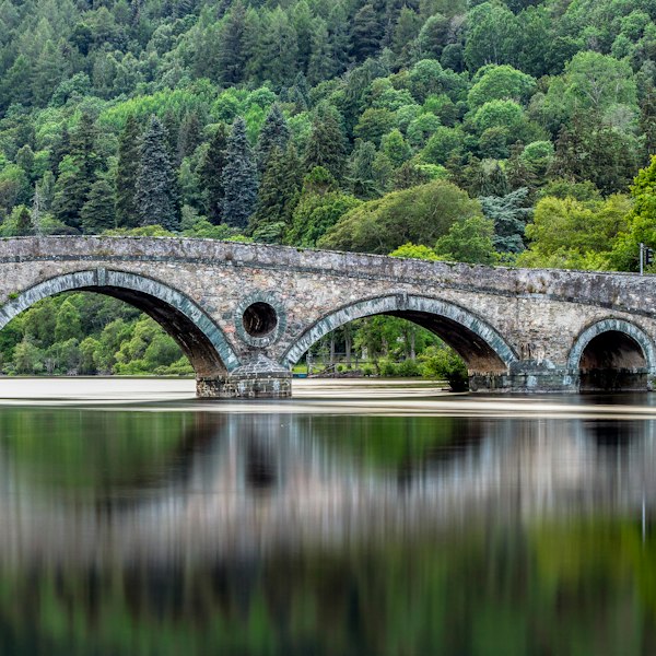 gray concrete bridge over river