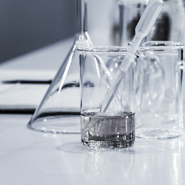 three clear beakers placed on tabletop